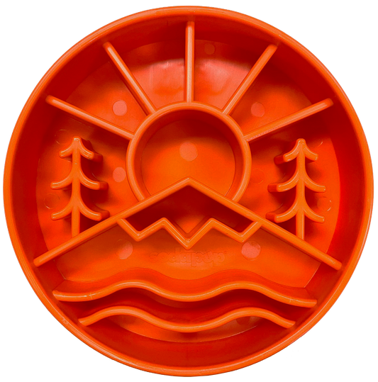 Orange Great Outdoors slow feeder dog bowl with raised ridges shaped like mountains and trees for mental enrichment and slow eating