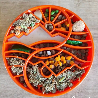 Orange Sun and Moon Design slow feeder dog bowl with kibble and mixed wet food in divided sections