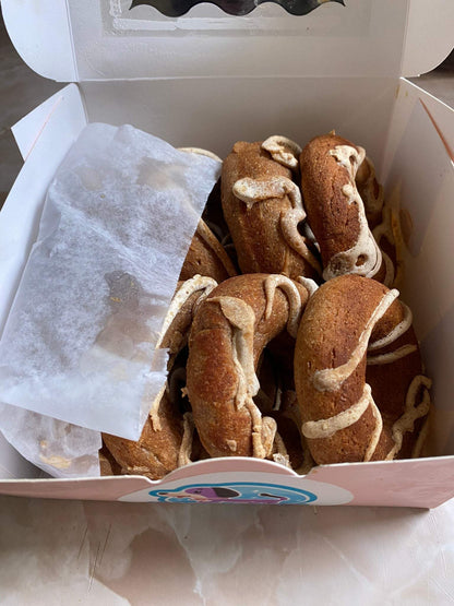 Box of organic peanut butter dog donuts with creamy drizzle, handmade and soft-baked treats for dogs