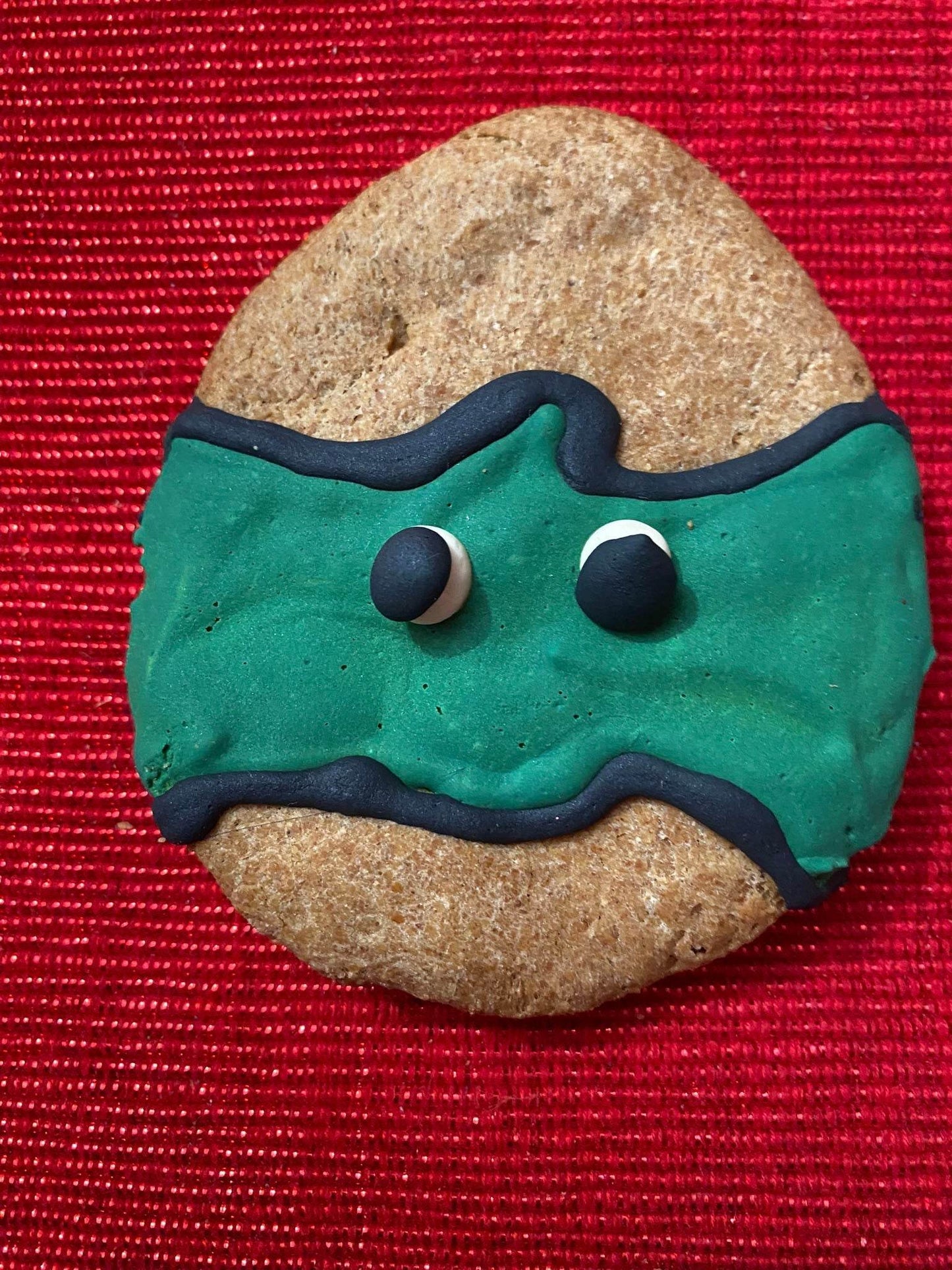 Dinosaurs Organic Dog Cookie Box dinosaur-shaped organic dog treat with green icing on red background