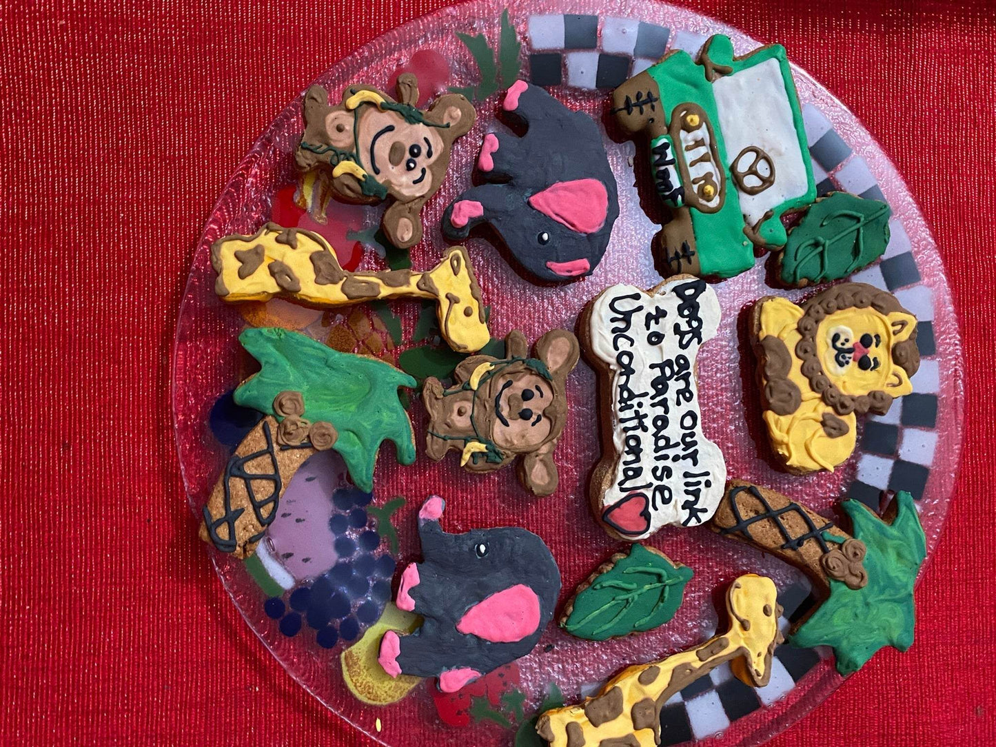 Dinosaurs Organic Dog Cookie Box with colorful, playful animal-shaped organic dog treats on a festive plate