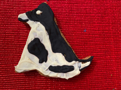 Organic dog-shaped cookie from Dog Life Organic Dog Cookie Box on red background