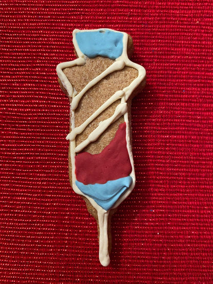 Get Well Organic Dog Cookie Box peanut butter dog cookie shaped like an IV drip with red, white, and blue icing on a red background