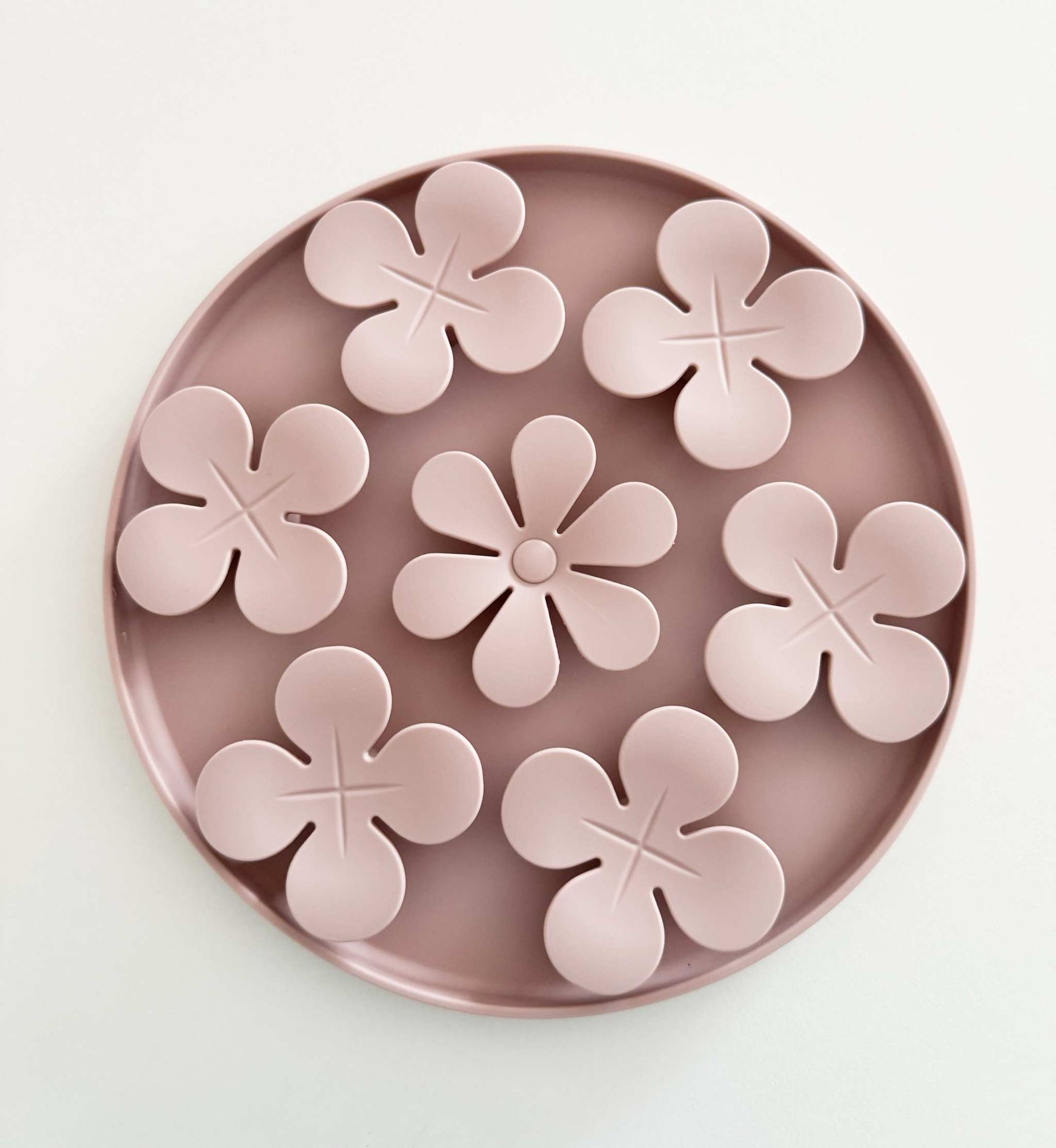 round pink snuffle mat flowers for pet enrichment on white background