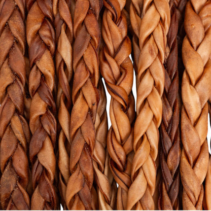 Close-up of all-natural braided collagen stick dog treats in various shades of brown