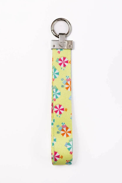 Sun and Shade Dog Bandana matching keychain with colorful beach umbrella pattern on yellow background