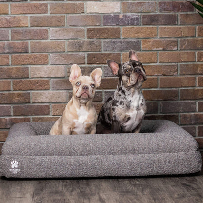 Luxury orthopedic dog bed with memory foam, plush boucle cover, and raised bolsters for joint support and comfort