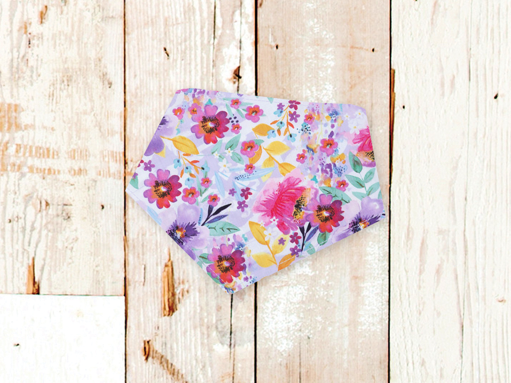 Lilac Watercolor Dog Bandana with floral print and adjustable snaps on wooden background