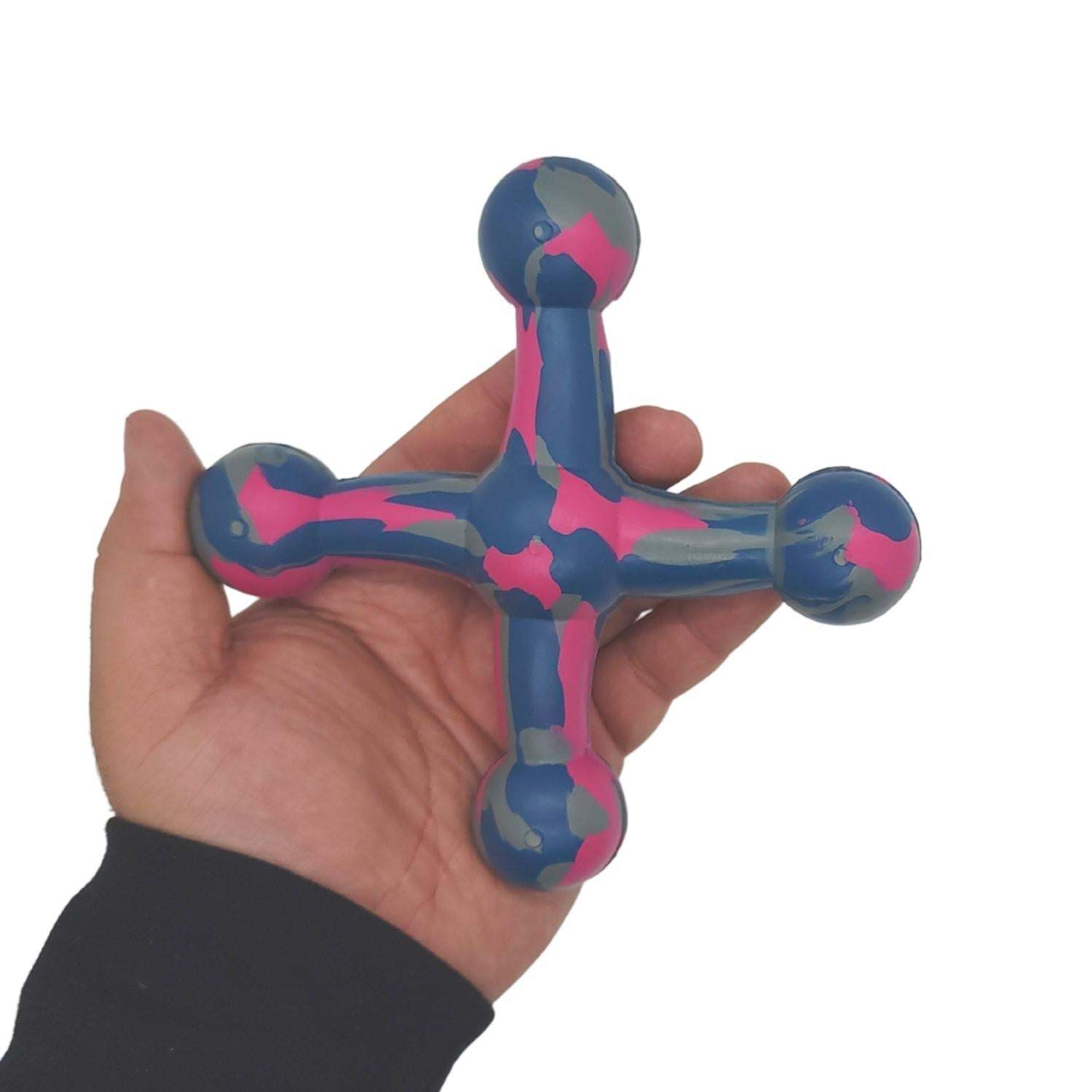 Natural rubber jack dog toy in blue, pink, and gray, held in hand for durable and non-toxic pet play