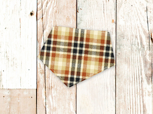 Orange Navy Plaid flannel dog bandana with adjustable snap closures on wooden background