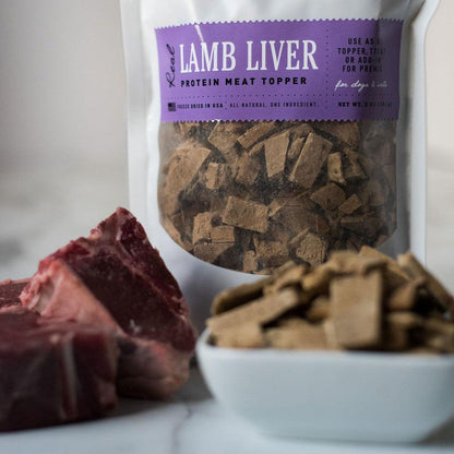 Freeze dried lamb liver protein meat topper for dogs in resealable bag with fresh raw lamb pieces and bowl of freeze dried liver pieces