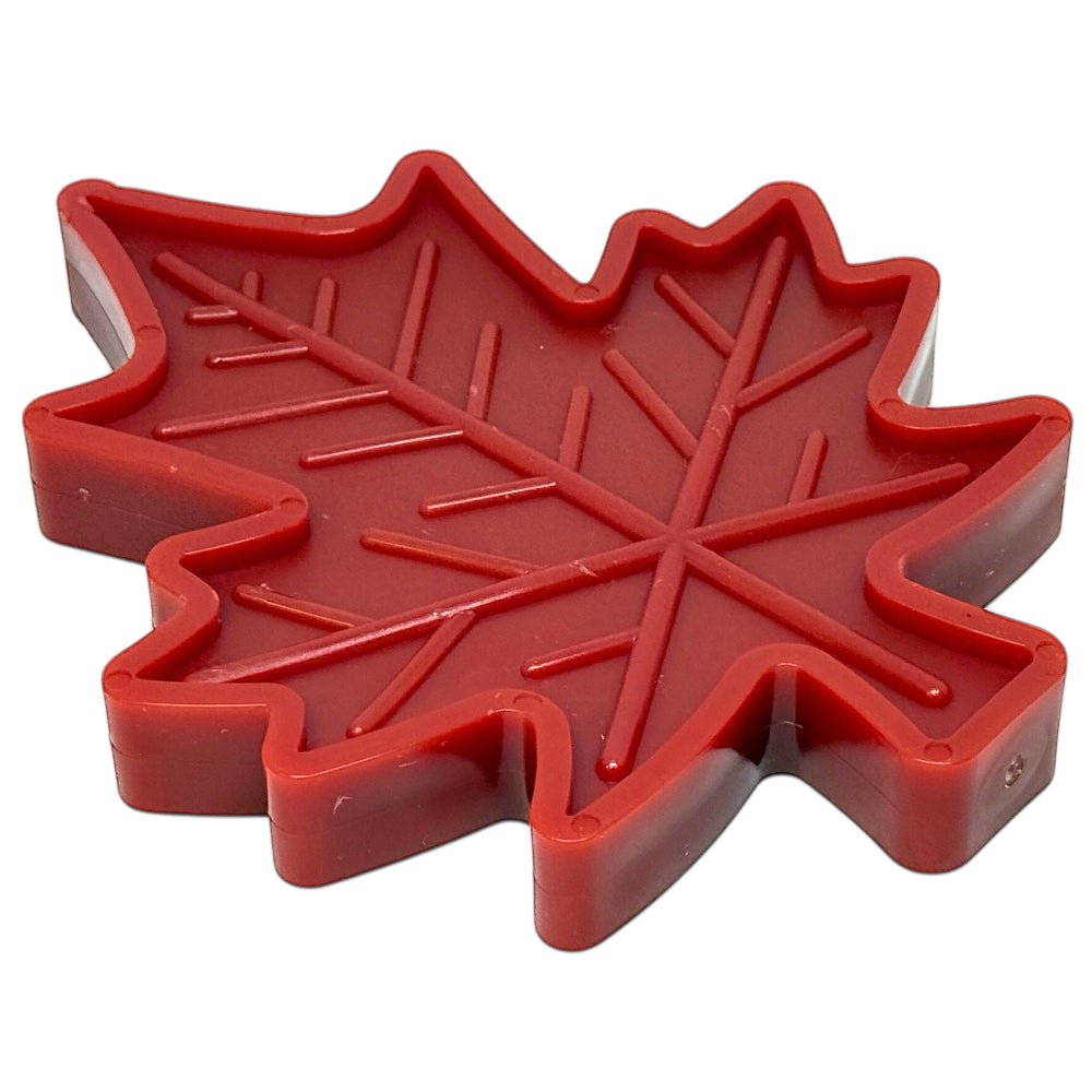 Red Canadian maple leaf-shaped indestructible nylon dog chew toy with textured surface for heavy chewers
