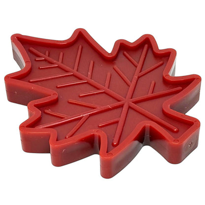 Red Canadian maple leaf-shaped indestructible nylon dog chew toy with textured surface for heavy chewers