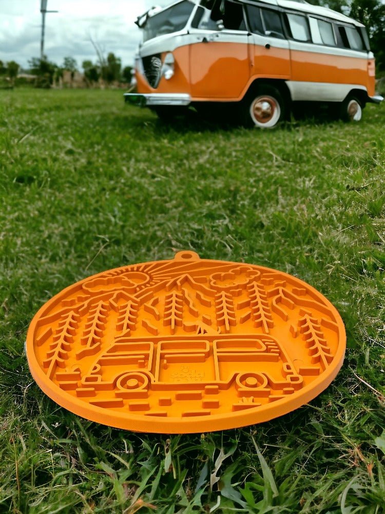 Orange Camp eMat dog lick mat with retro camper van design on grass outdoors