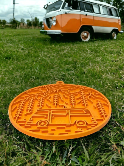 Orange Camp eMat dog lick mat with retro camper van design on grass outdoors