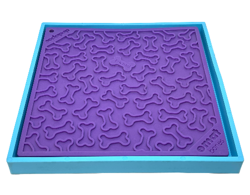 Hold 'em suction cup holder securing a purple dog lick mat with bone patterns on a blue frame