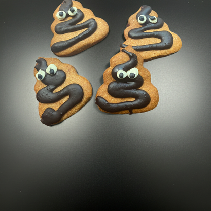 Poop Organic Dog Cookies shaped like poop emoji with chocolate and eyes on black surface, organic peanut butter dog treats