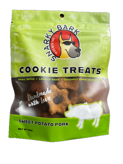 Snarky Bark sweet potato pork dog cookie treats in green BPA free packaging, made with local, grass-fed pork and pesticide-free sweet potatoes