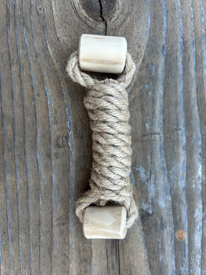 eco-friendly hemp rope and coffee wood interactive dog toy on wooden background
