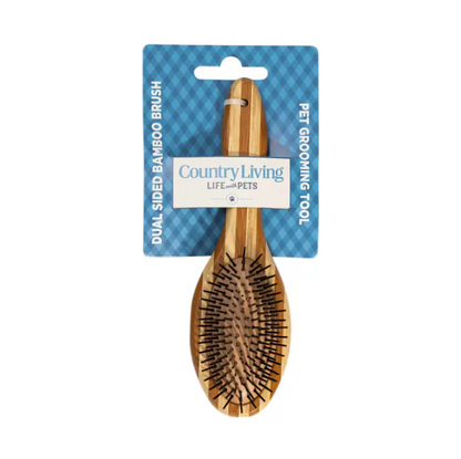 Country Living dual-sided natural wood dog brush with ergonomic handle and bristle and pin sides for grooming and detangling pets.