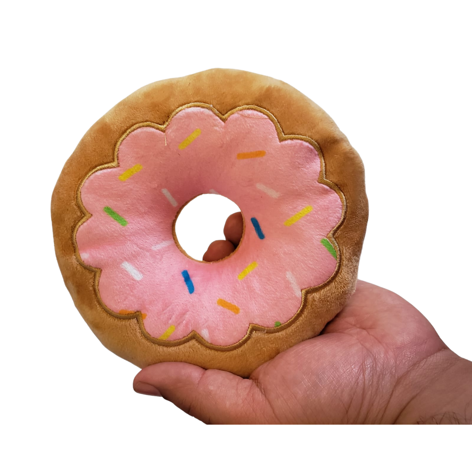 Strawberry donut plush dog toy held in hand, soft and durable for chewing and play