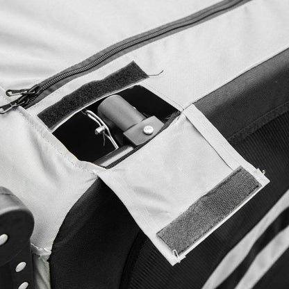 Close-up of grey fabric and zipper detail on 2-in-1 pet bike trailer stroller with Velcro flap and metal frame component visible