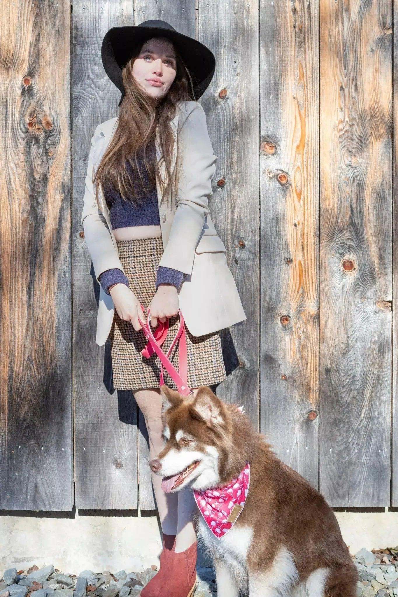 woman with dog wearing wine plaid dog bandana on pink leash outdoors