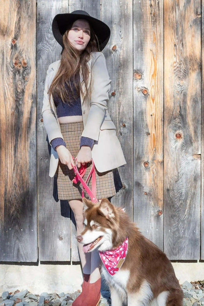 woman with dog wearing wine plaid dog bandana on pink leash outdoors