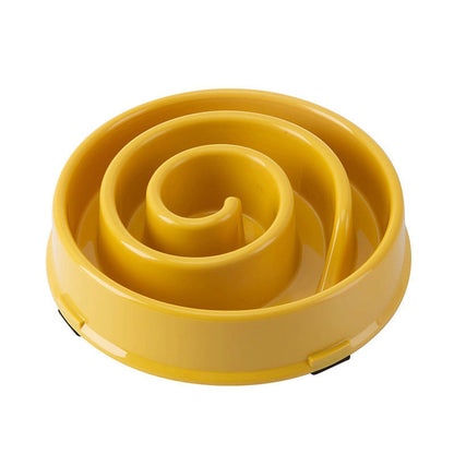 Anti-Choke Slow Feeder Bowl in mustard yellow plastic, with a raised spiral maze and non-slip base grips.