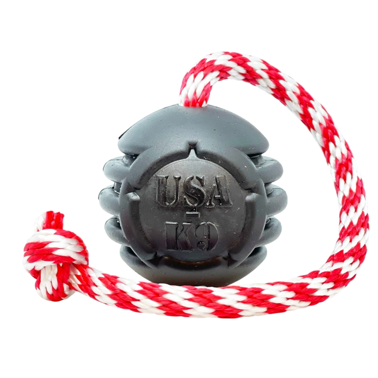 USA-K9 Magnum black rubber chew toy ball with red and white tug rope for durable dog play