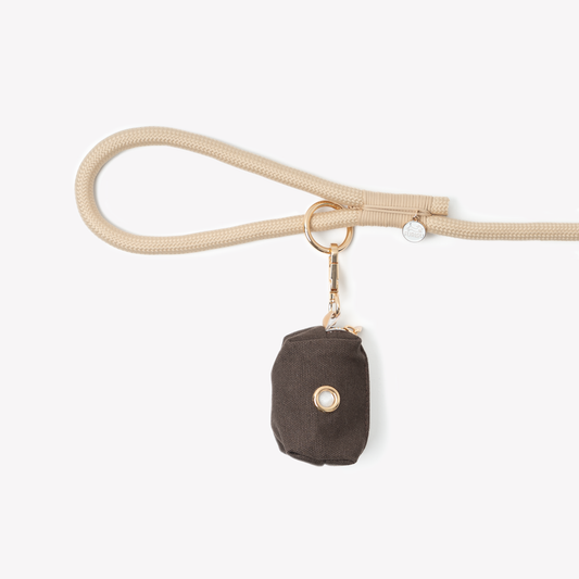 brown poop bag holder clipped on leash