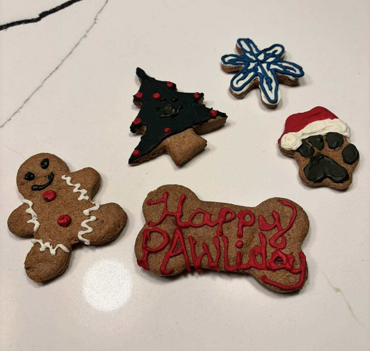 Festive Christmas dog peanut butter cookies with holiday decorations