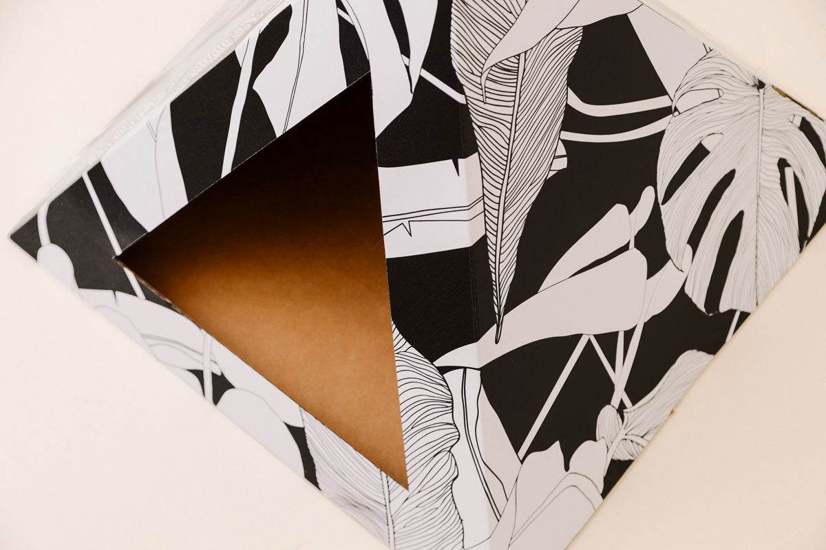 Dark Paradise Cardboard cat pyramid with black and white tropical leaf design for cozy cat hideaway and modern decor