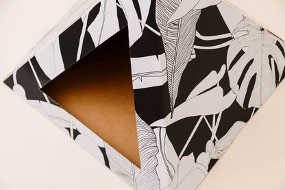 Dark Paradise Cardboard cat pyramid with black and white tropical leaf design for cozy cat hideaway and modern decor