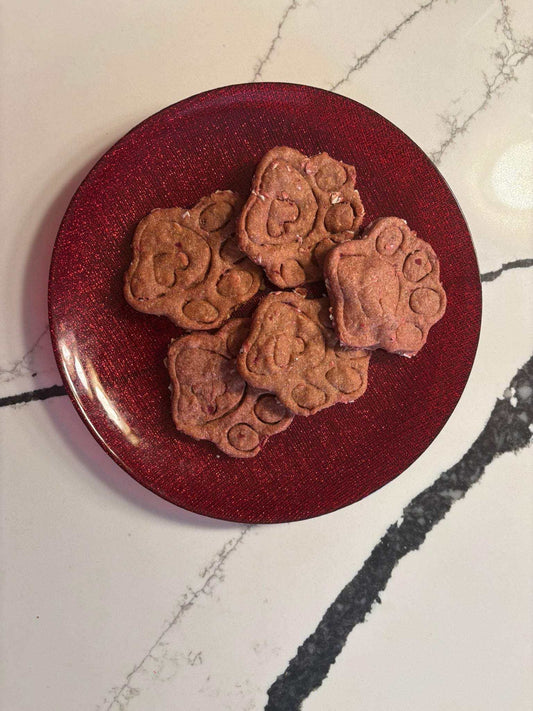 Crunchy beet and peanut butter organic dog treats shaped like paws