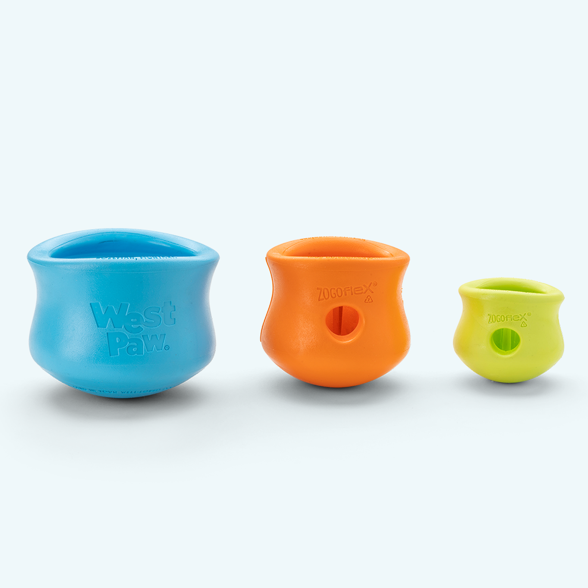 Customizable puzzle and treat toy set featuring blue, orange, and lime green sizes made of durable rubber for dogs