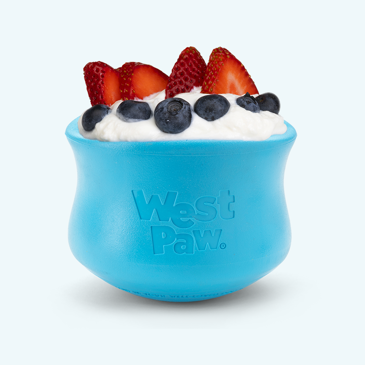 customizable puzzle and treat toy in durable blue rubber material filled with white cream topped with fresh strawberries and blueberries
