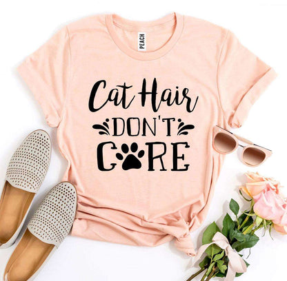 Peach Cat Hair Don't Care T-Shirt with black text and paw print, paired with beige slip-on shoes, sunglasses, and pink roses.
