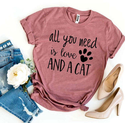 Pink Bella Canvas t-shirt with "All you need is love and a cat" text and paw print design
