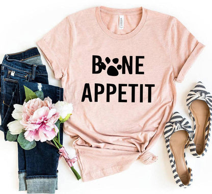 Pink Bone Appetit T-Shirt with paw print design, paired with jeans, flowers, and striped shoes
