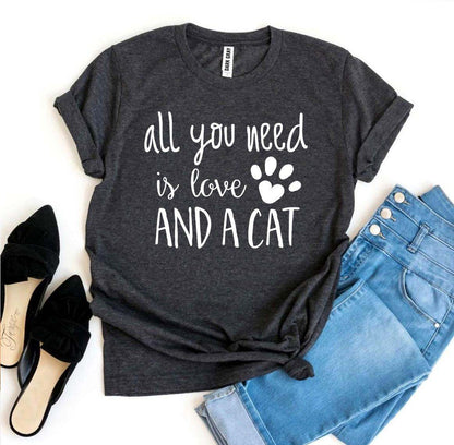 Dark grey Bella Canvas t-shirt with "all you need is love and a cat" text and paw print, paired with blue jeans and black shoes.