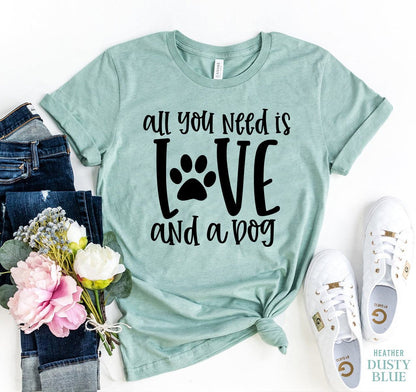 Light green Bella Canvas t-shirt with "All You Need Is Love and a Dog" text and paw print design, soft cotton fabric.