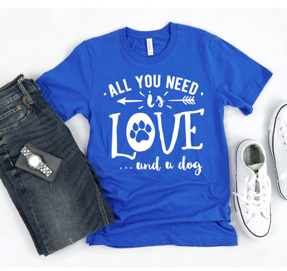 Blue All You Need Is Love And A Dog T-shirt with white text and paw print design, paired with jeans and white sneakers