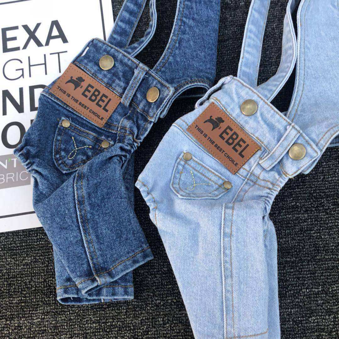 Denim Jumpsuit for Small Pets in dark and light blue with brown label patches and adjustable strap buckles