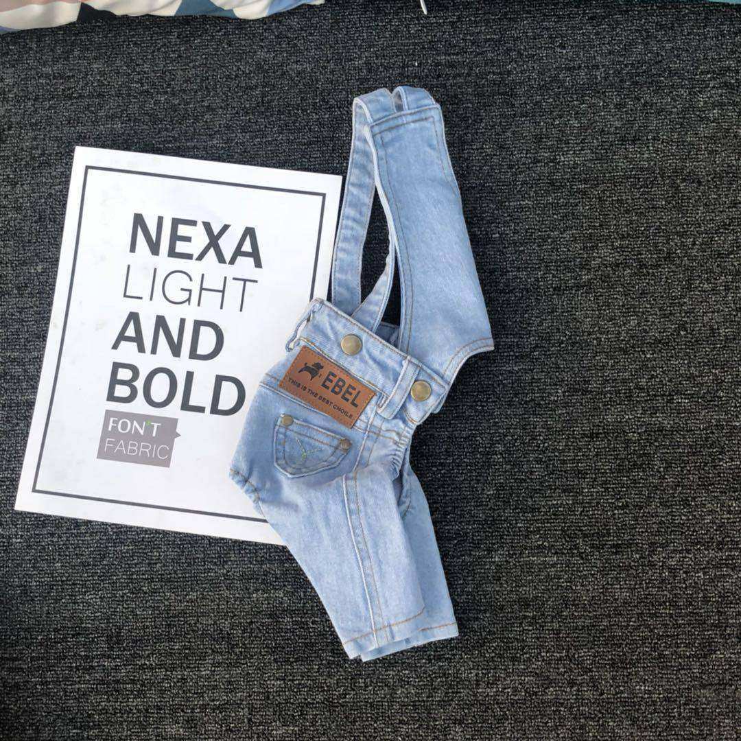 Denim Jumpsuit for Small Pets in light blue wash with adjustable straps and brown faux leather patch detail