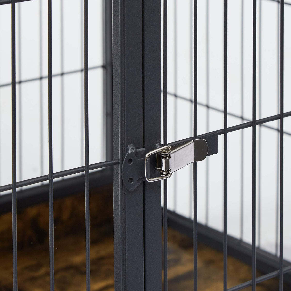 Dog Crate Side Table with black steel bars and a silver metal latch securing the front door