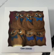 Organic Peanut Butter Dog Cookies by Finn's in a gift box with blue bow tie decorations