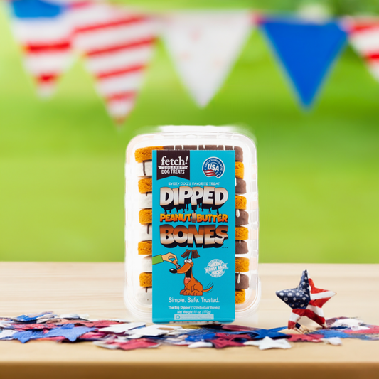 Package of 'Merica Dipped Bones peanut butter dog treats on patriotic table setting with American flag bunting background