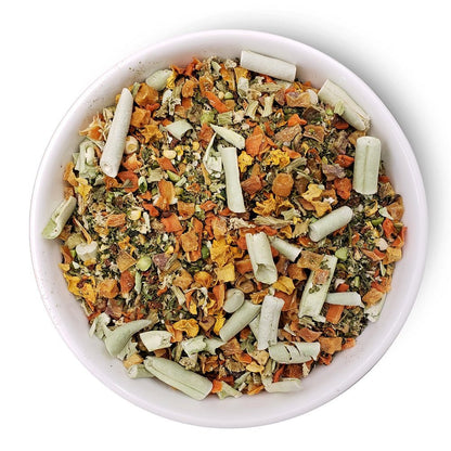 grain free dog food premix in white bowl with mixed dried vegetables and herbs