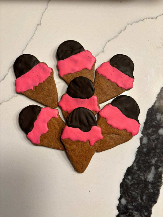 Ice Cream Organic Dog Treats shaped like ice cream cones with pink and chocolate-colored coatings on a white surface